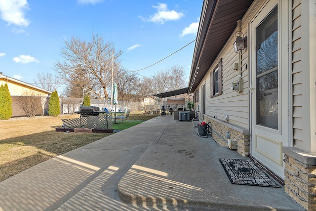 view of patio with central AC, a fenced backyard, and a trampoline