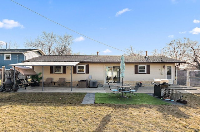 back of property with a patio area, central AC unit, a lawn, and fence