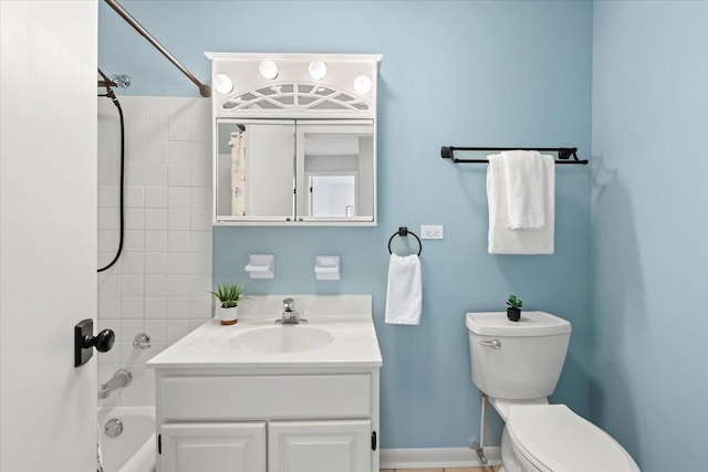 bathroom with baseboards, toilet, vanity, and shower / bathing tub combination