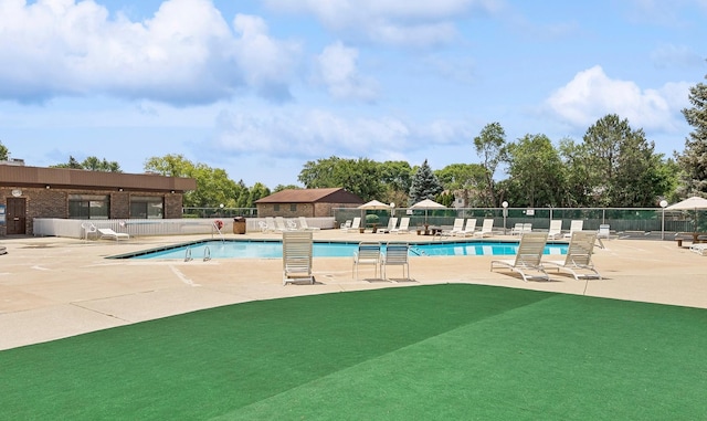 pool featuring a patio area and fence