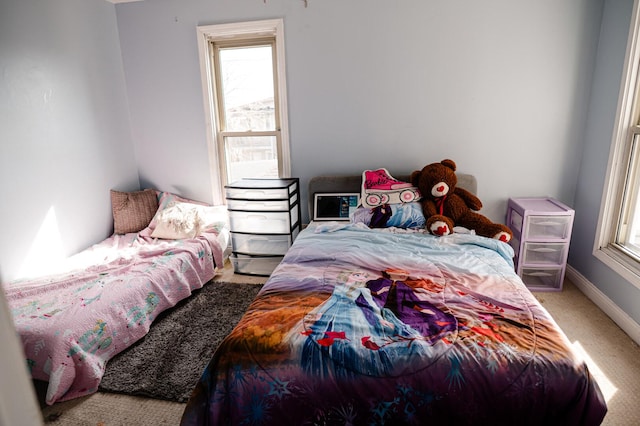 carpeted bedroom featuring baseboards