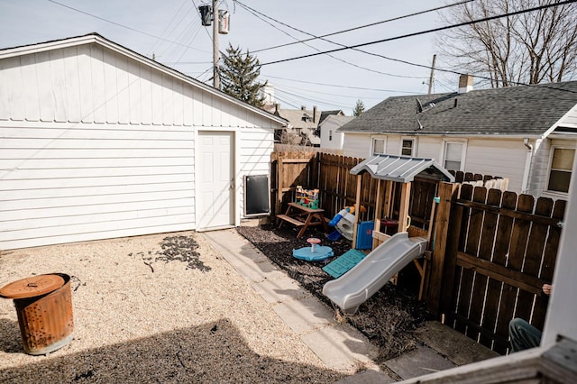 exterior space featuring a playground and fence