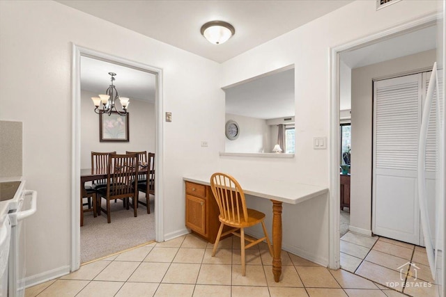 dining area with an inviting chandelier, light tile patterned flooring, light colored carpet, and baseboards