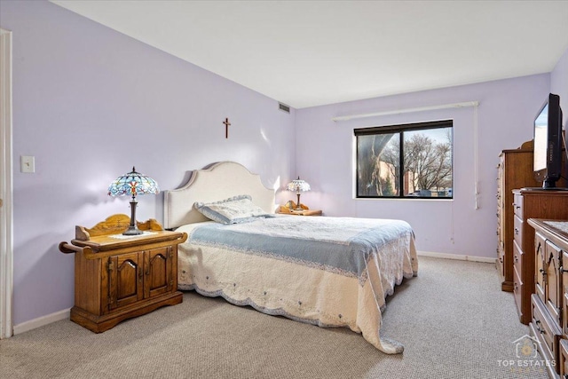 carpeted bedroom featuring visible vents and baseboards