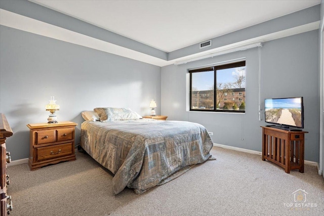 carpeted bedroom featuring visible vents and baseboards