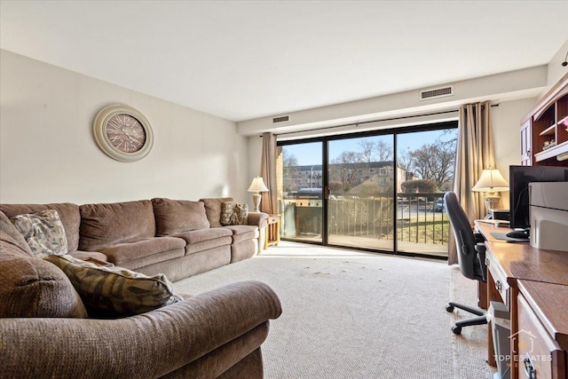 living area with visible vents and carpet flooring