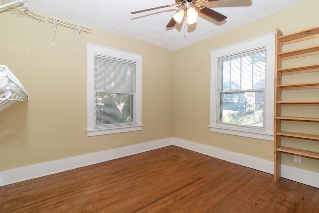 spare room with ceiling fan, baseboards, and wood finished floors