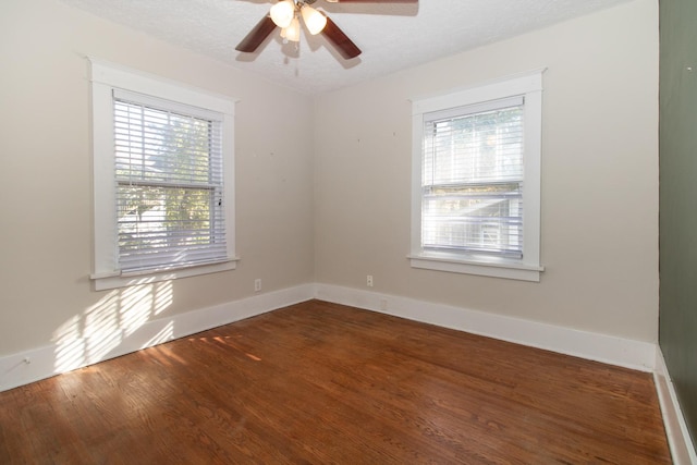 spare room featuring ceiling fan, baseboards, a textured ceiling, and wood finished floors