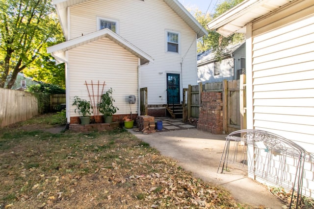 back of property featuring a patio and fence