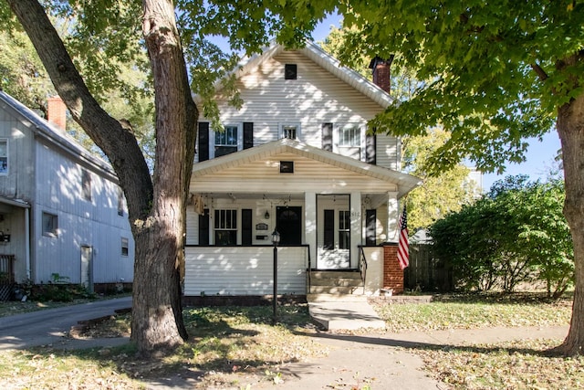 view of front of property with a porch and a chimney