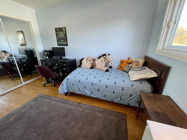 bedroom with a closet and wood finished floors