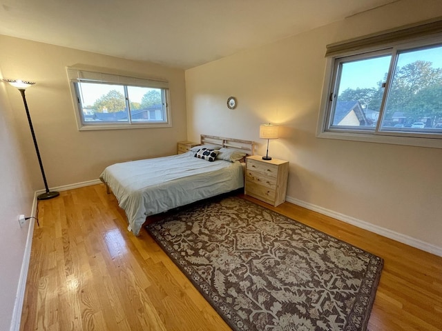 bedroom featuring baseboards and light wood-type flooring