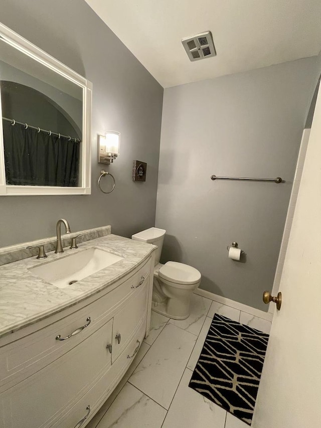 bathroom with vanity, visible vents, baseboards, toilet, and marble finish floor