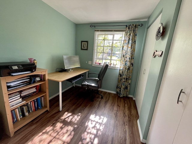 home office with baseboards and wood finished floors