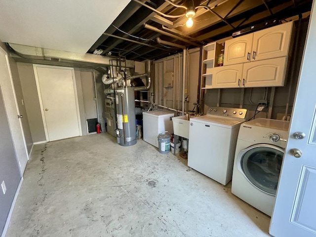 unfinished basement featuring gas water heater, fridge, washing machine and dryer, and a sink