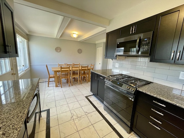 kitchen featuring gas range oven, marble finish floor, stainless steel microwave, beamed ceiling, and tasteful backsplash