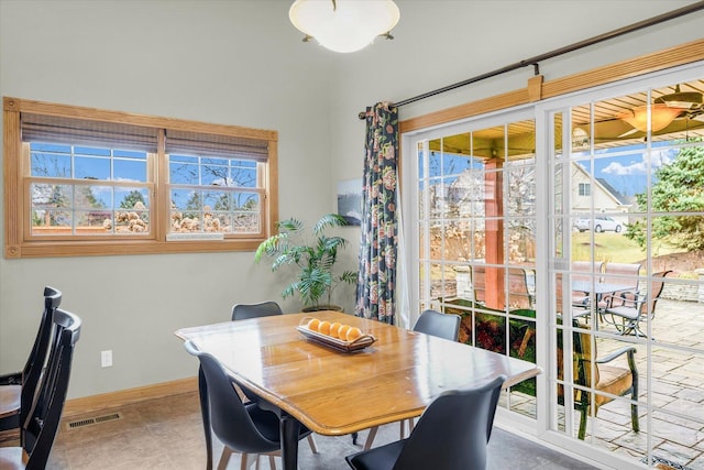 dining room featuring tile patterned floors, baseboards, and visible vents