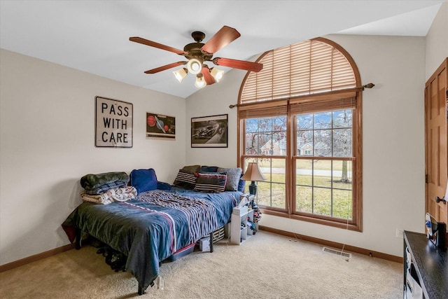 bedroom featuring vaulted ceiling, baseboards, visible vents, and light carpet