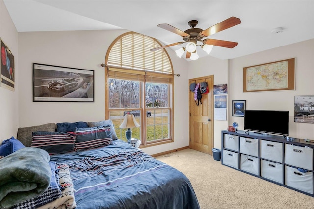 bedroom with vaulted ceiling, a ceiling fan, baseboards, and carpet floors