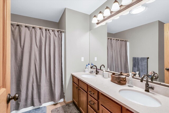 bathroom featuring double vanity, tile patterned flooring, and a sink