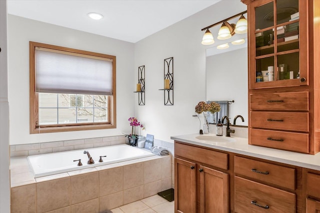 full bath with tile patterned flooring, vanity, and a garden tub