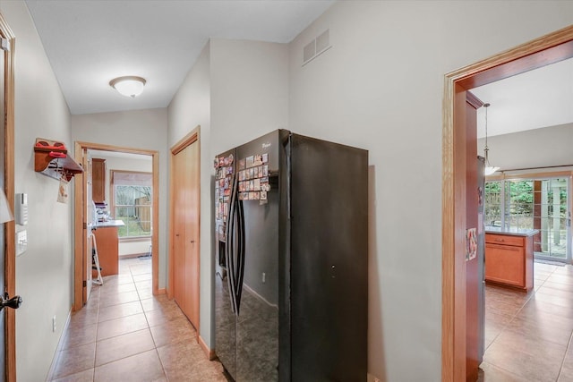 hallway with light tile patterned floors and visible vents