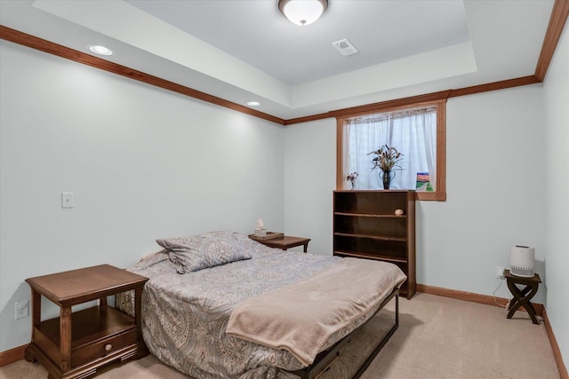 bedroom with visible vents, crown molding, baseboards, light carpet, and a raised ceiling