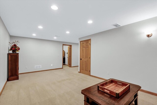 sitting room with recessed lighting, visible vents, and light carpet