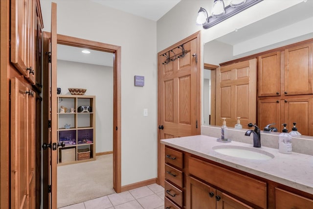 bathroom featuring tile patterned flooring, vanity, and baseboards