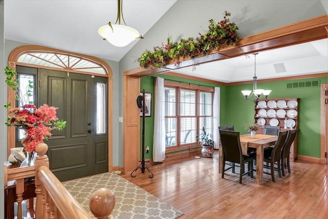 entryway featuring light wood finished floors, plenty of natural light, and visible vents