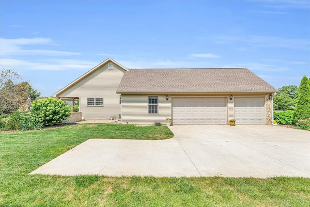 exterior space with driveway, a lawn, roof with shingles, and an attached garage