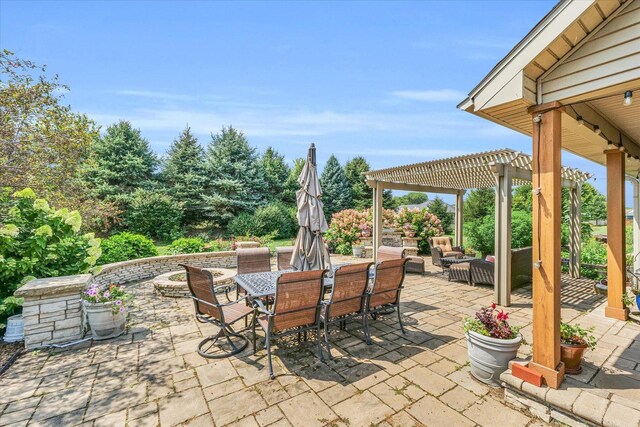 view of patio featuring a pergola and outdoor dining area