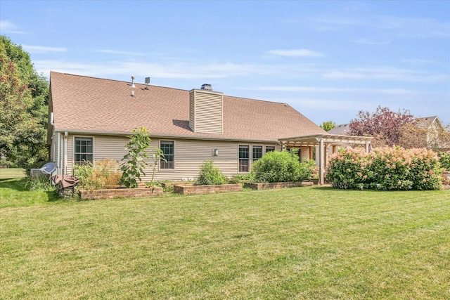 rear view of house with a shingled roof, a lawn, a pergola, and a chimney