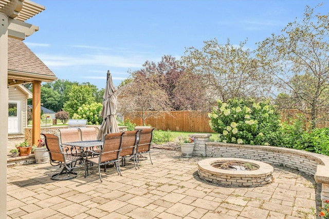 view of patio with outdoor dining space and fence