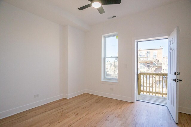 spare room featuring visible vents, baseboards, light wood-style floors, and ceiling fan