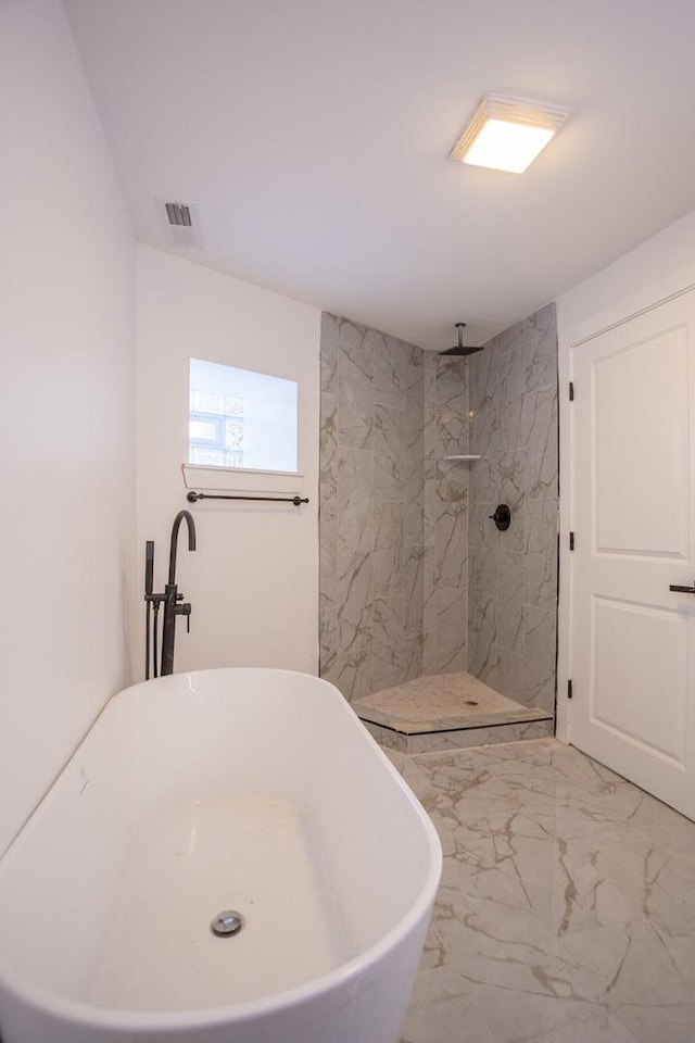 bathroom with visible vents, marble finish floor, a marble finish shower, and a freestanding bath