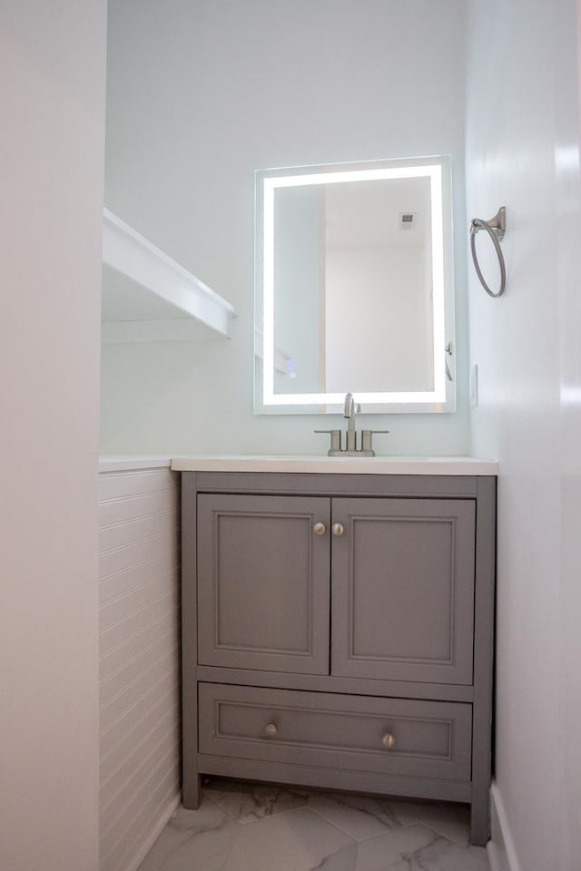 bathroom with visible vents, marble finish floor, and vanity