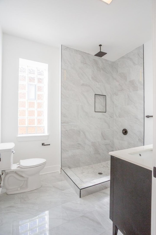 full bath featuring baseboards, walk in shower, toilet, marble finish floor, and vanity