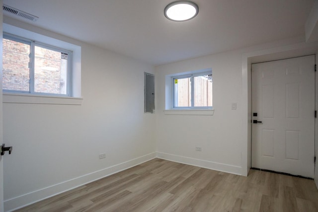 spare room featuring visible vents, baseboards, and light wood-style flooring