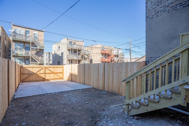 view of yard with a fenced backyard and a gate
