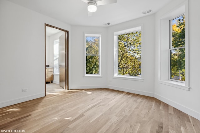 unfurnished dining area featuring visible vents, light wood-style flooring, a ceiling fan, and baseboards