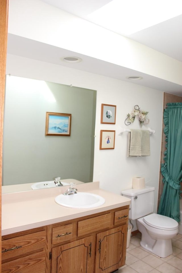 bathroom featuring a shower with curtain, toilet, vanity, and tile patterned flooring