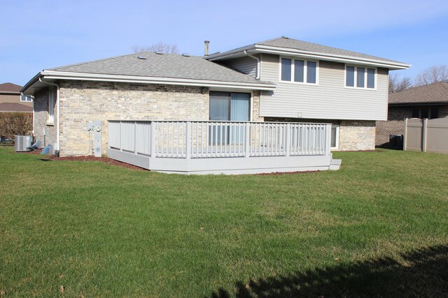 view of exterior entry with brick siding, a lawn, and a shingled roof