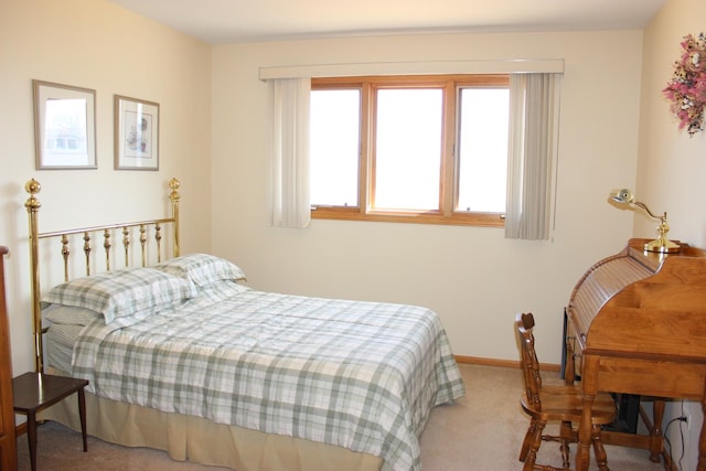 bedroom featuring carpet flooring, multiple windows, and baseboards