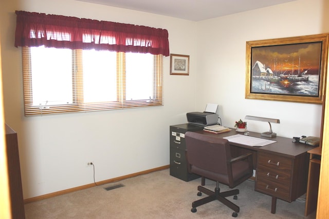 carpeted office featuring visible vents and baseboards