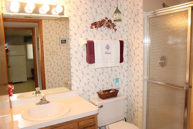 bathroom featuring wallpapered walls and a shower stall