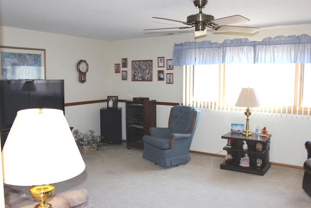 interior space with carpet flooring, wallpapered walls, baseboards, and a ceiling fan