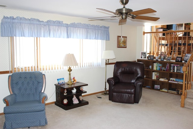 living area with a ceiling fan, baseboards, visible vents, wallpapered walls, and carpet flooring