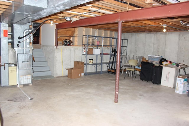 unfinished below grade area with heating unit and stairs