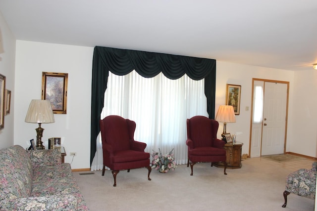 living room with carpet and baseboards